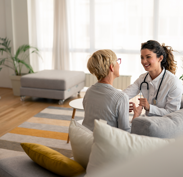 Smiling doctor visiting senior woman at home