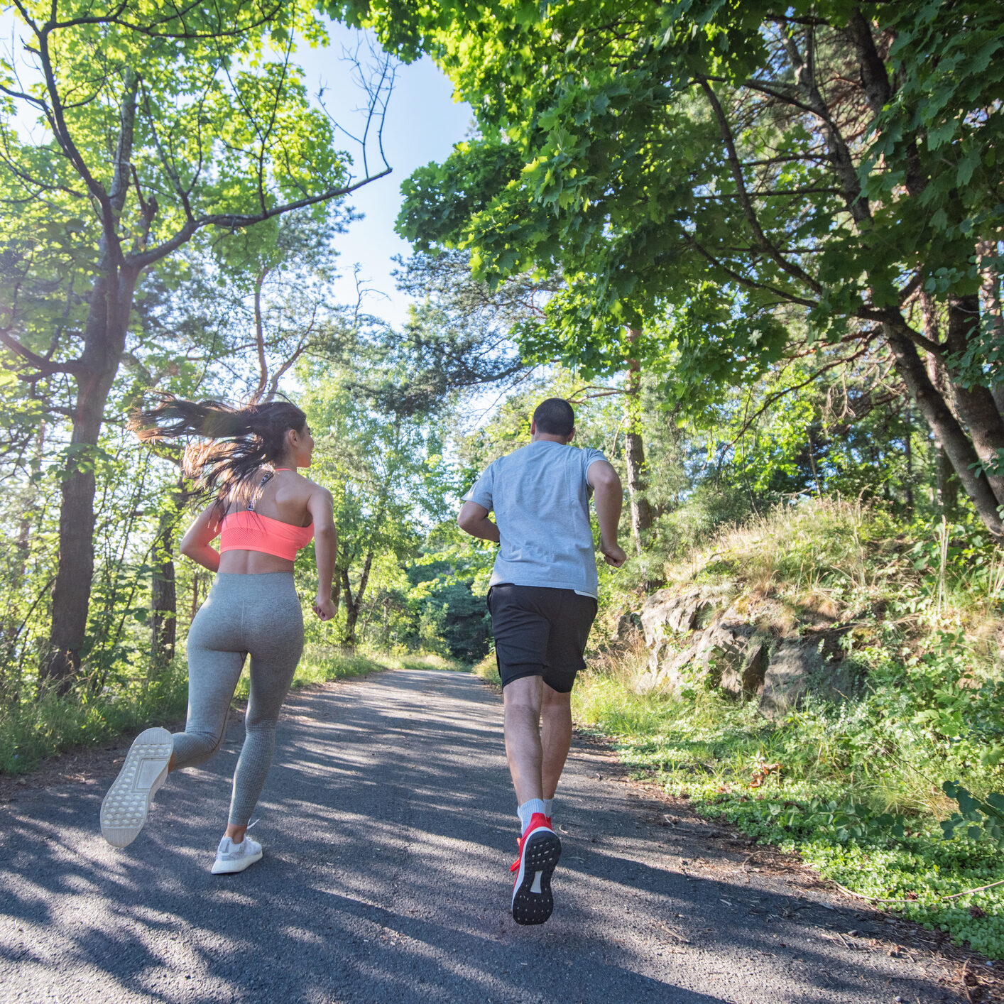 Couple jogging early in the morning at the park.